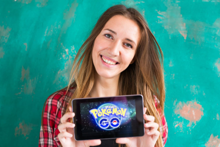 90318242_woman-show-the-tablet-with-pokemon-go-logo.jpg