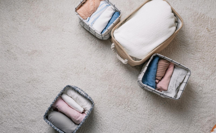 41406560_neatly-folded-clothes-in-open-organizer-boxes-top-view-cleaning-method.jpg